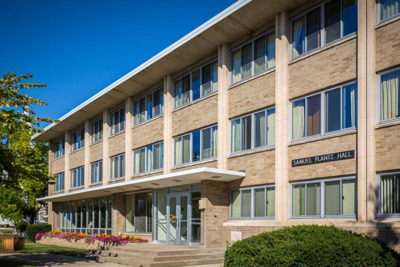 Long 3-story building against blue sky