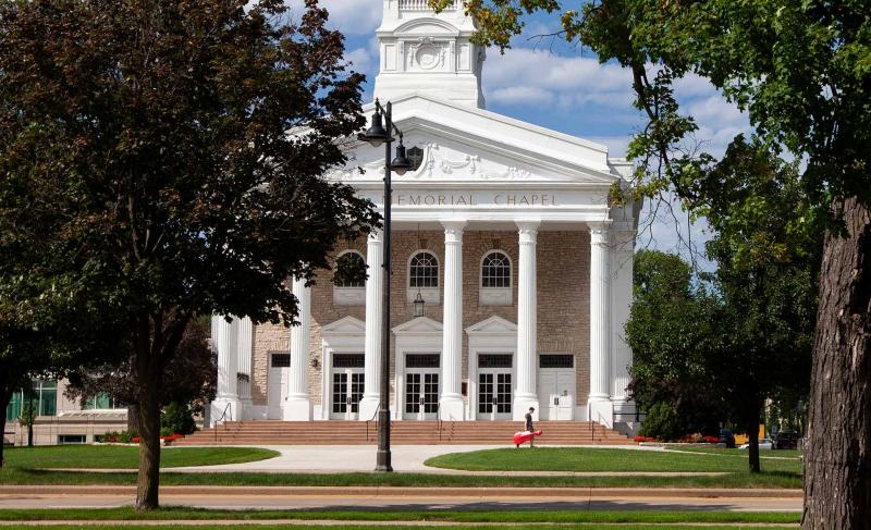 A student walks in front of Memorial Chapel