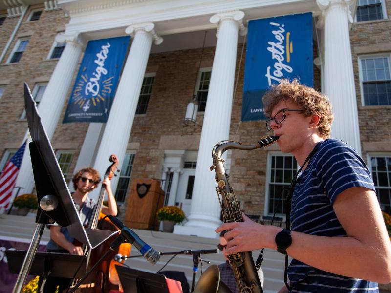 Students are playing music during the President's Welcome event on Main Hall Green