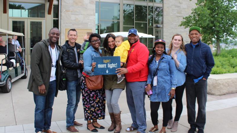 Group of alumni pose for picture outside the Warch Campus Center