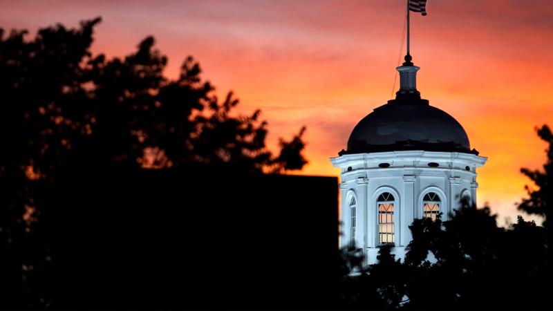 The Main Hall cupola is illuminated as the sun sets