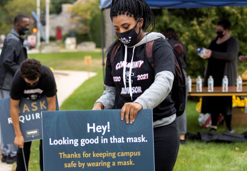 Students placing signage for welcome week