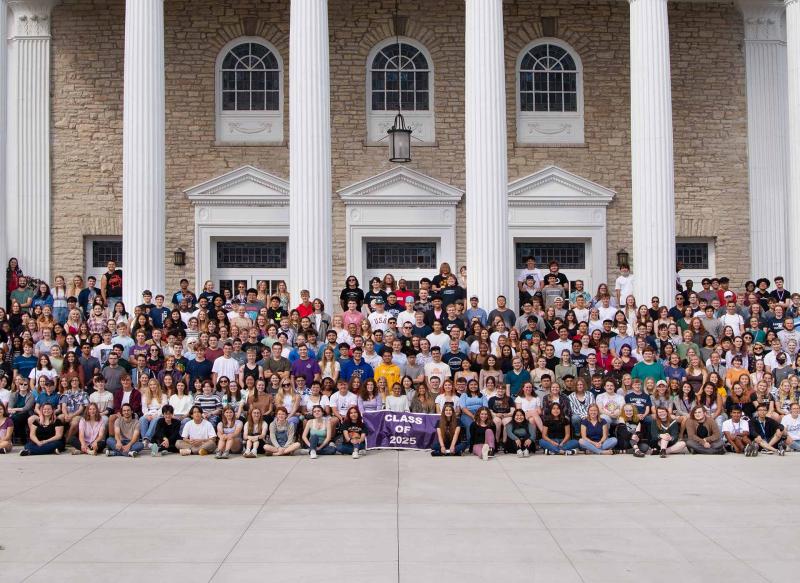 Students pose for their official class of 2025 class photo in front of Memorial Chapel