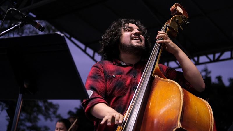 Student playing bass on stage at LUaRoo