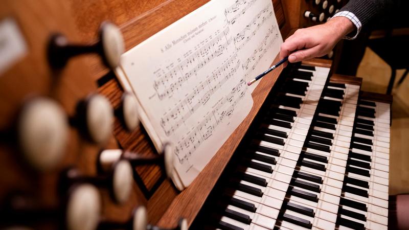 Close up organ keys and music sheets