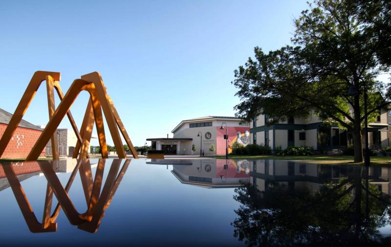 Aerial Landscape sculpture, the Wellness Center, and Sampson House reflected just before sunset.