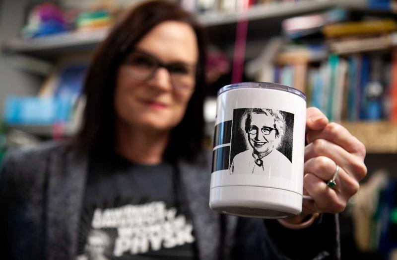 A black and white photo of Elda Anderson is featured on a white coffee mug held by Megan Pickett.