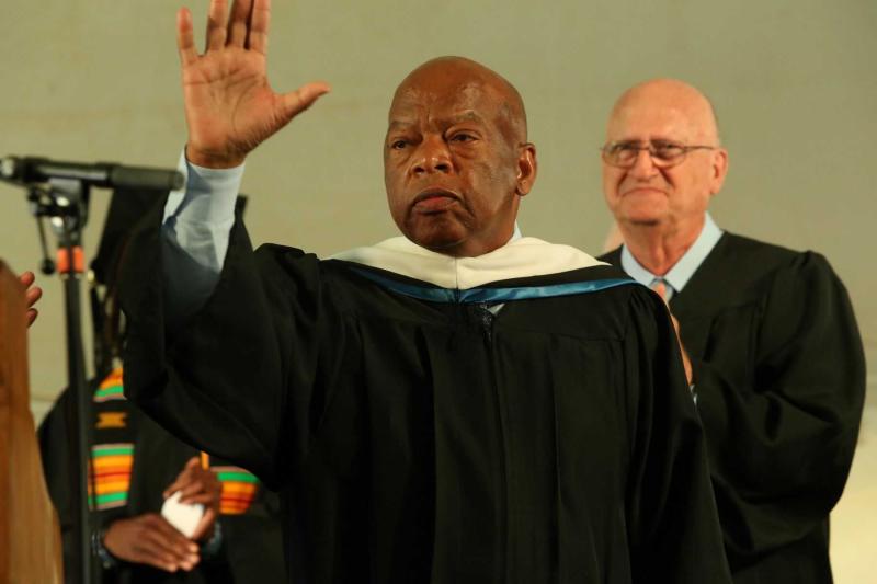 John Lewis waves from the stage during the 2015 Commencement ceremony.