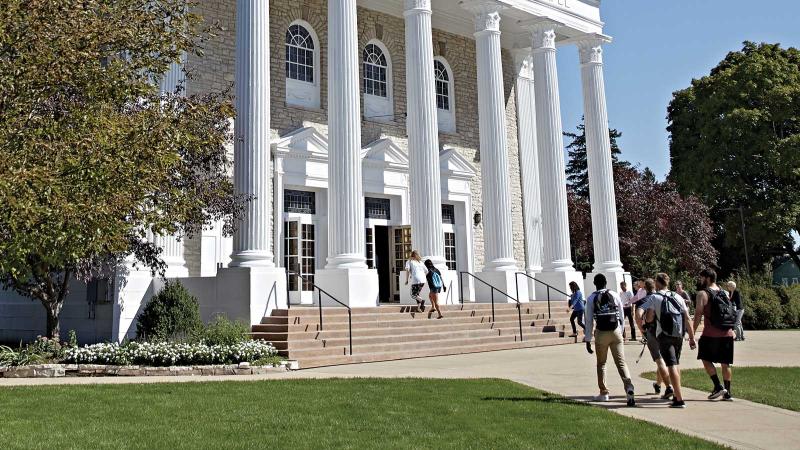 Students walk into Memorial Chapel on a sunny day