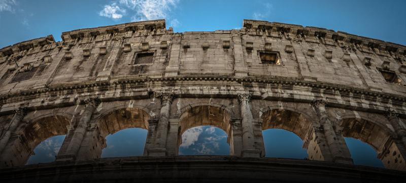 Looking up at one face of the Colosseum in Rome, Italy.