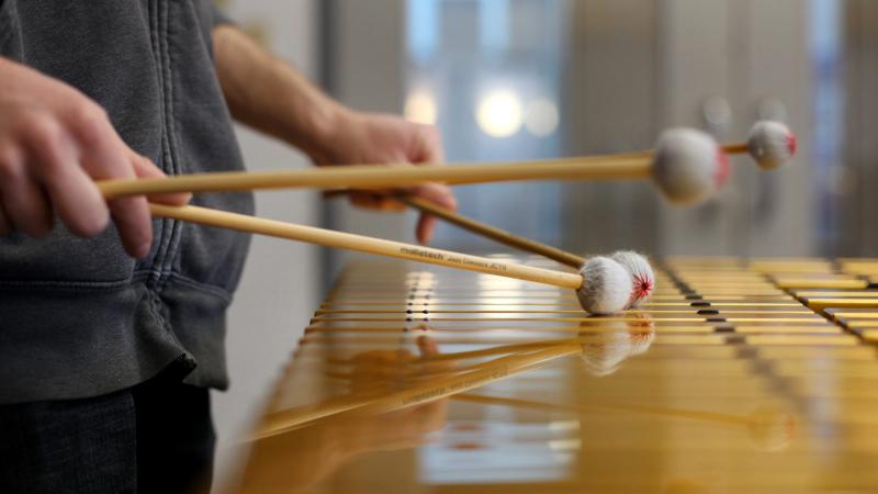 Close up of someone playing a xylophone 