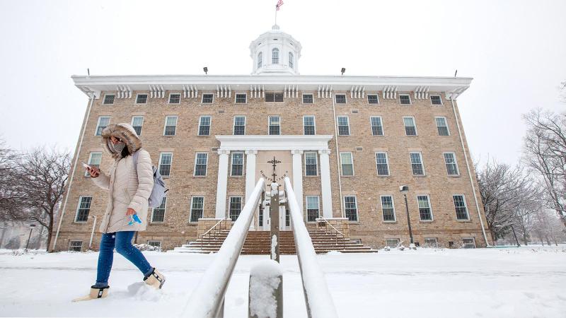 Students walking through snow near Main Hall