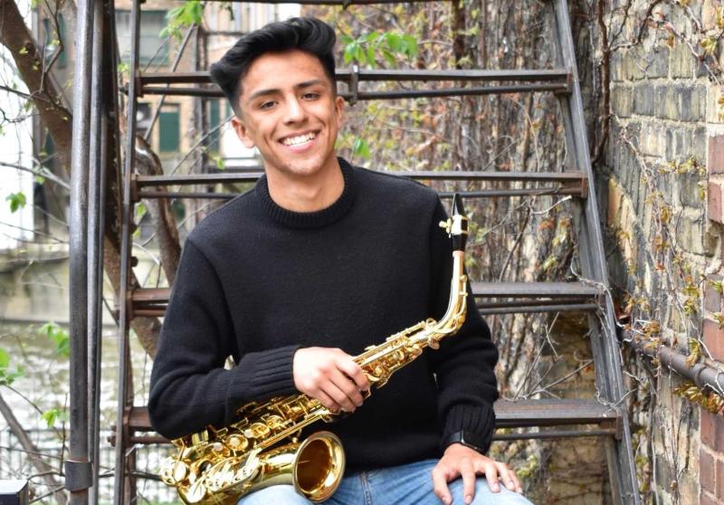 Luis Trejo poses with his saxophone.