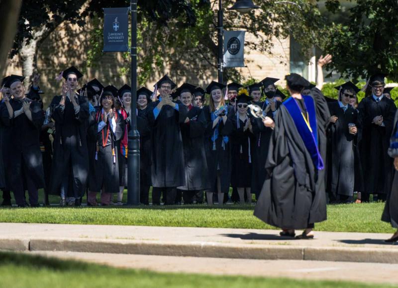 Graduates applaud the faculty as they walk the processional during 2022 Commencement.