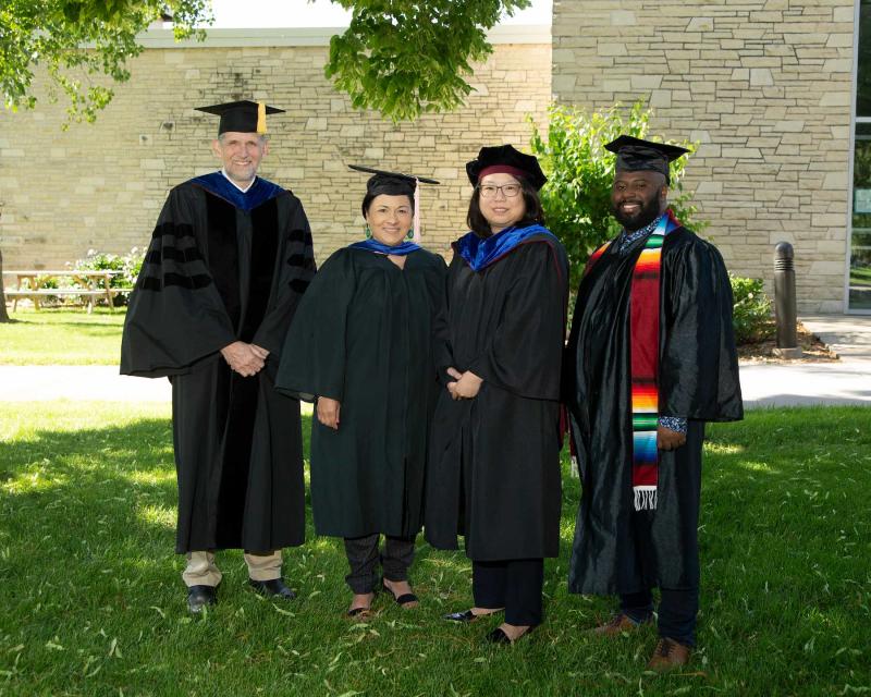 Faculty award winners, from left, Peter Peregrine, Brigetta Miller, Nancy Lin, and Jesus Smith pose for a photo in their regalia.