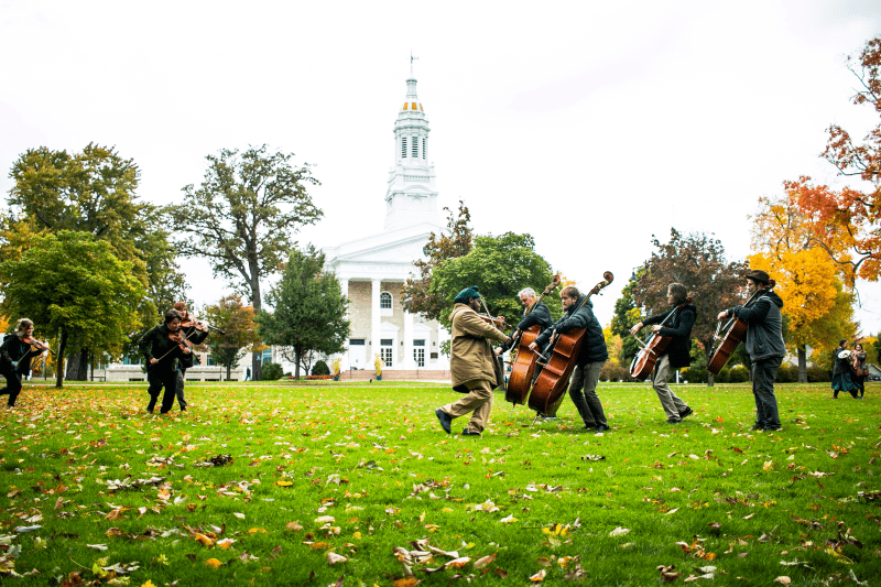 People play isntruments outside in front of Lawrence Chapel