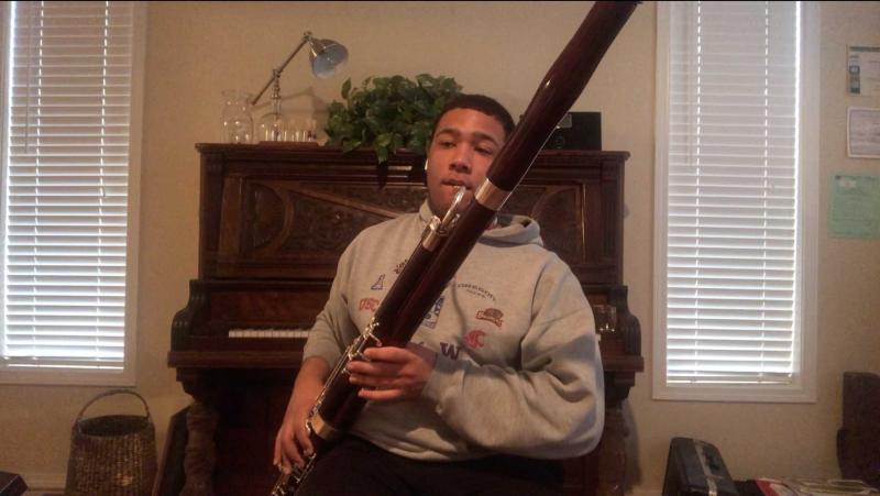 Nate Scott plays the bassoon while recording remotely for the Coming Together project.
