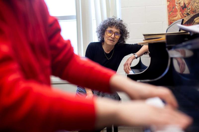 Catherine Kautsky watches as sophomore Jasmine Maller plays the piano during a teaching session.
