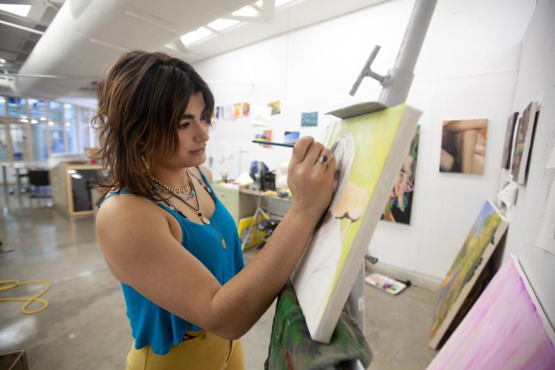 Marifé Entenza-Sierra works on her painting in Wriston Art Center.