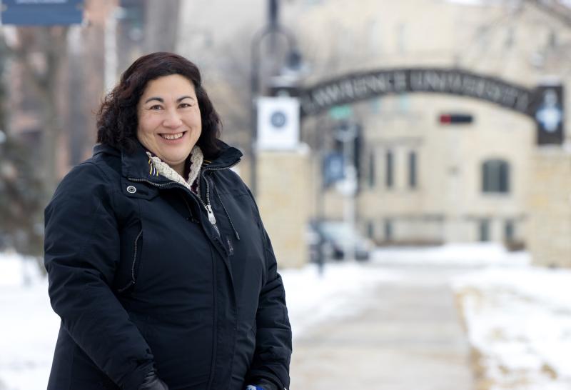 Monica Rico poses for a photo on the sidewalk leading to Main Hall.