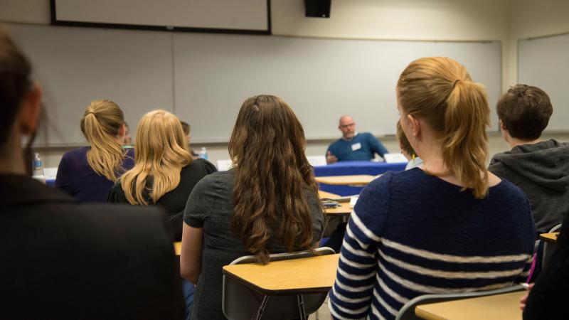 Advising Hero with students attending a panel discussion at a career fair