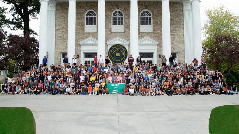 Class of 2023 in front of Main Hall with Lawrence Seal.