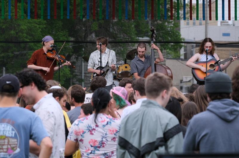 Four members of The Woebegones perform during the 2022 LUaroo festival on Main Hall Green as students cheer them on.