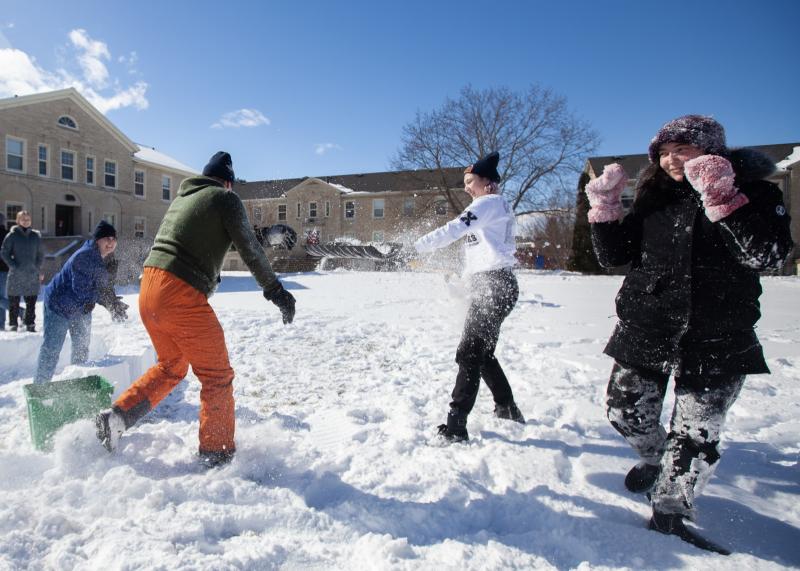 Lawrence students play in the snow during a LUgge snow-sculpture event in the Quad.
