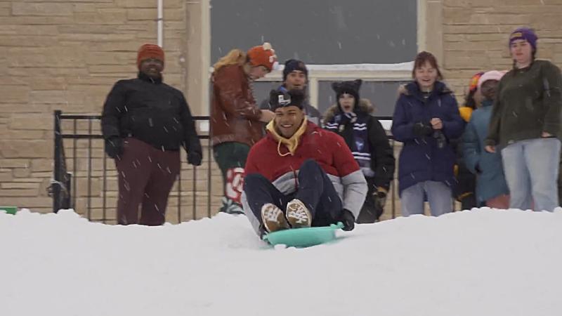 Students sledding down Slug Hill