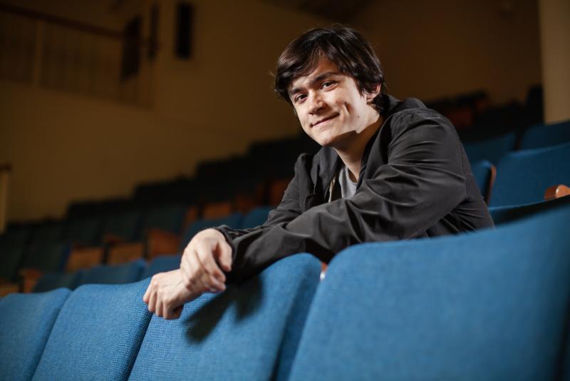 Jasper Kashou poses for a portrait in the seats of Memorial Chapel.