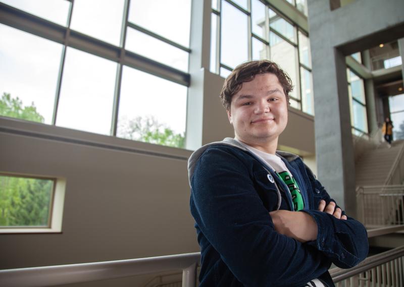 Anders Hanhan poses for a portrait on the steps inside Warch Campus Center.