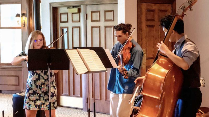 Trio of students playing stringed instruments