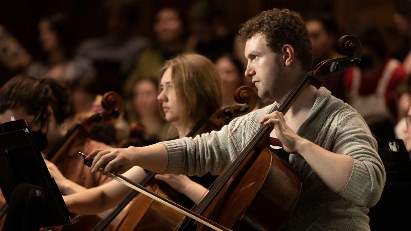 Cellists play intently during rehearsal in the Lawrence Chapel