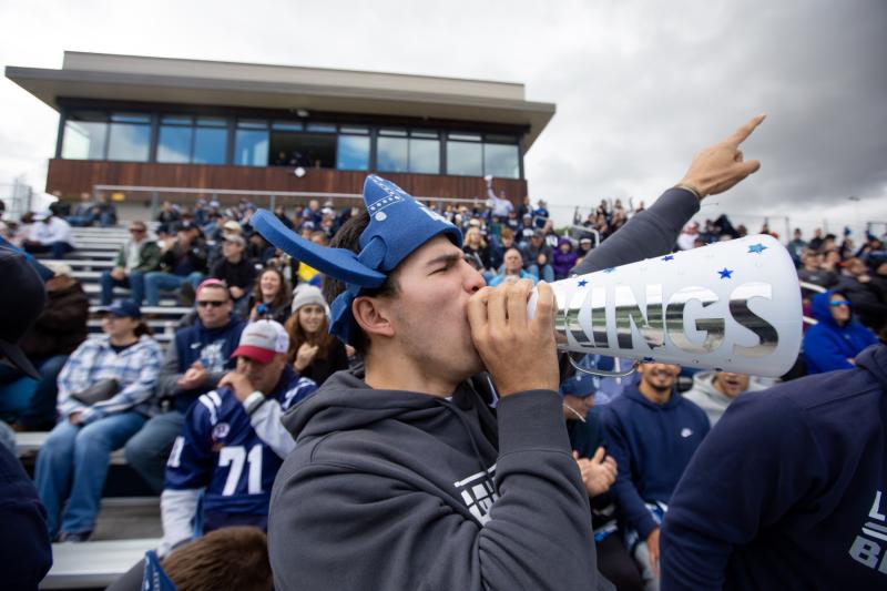 Nicolas Manzanera, a sophomore, cheers on the football team during Blue & White Homecoming Weekend at Banta Bowl.
