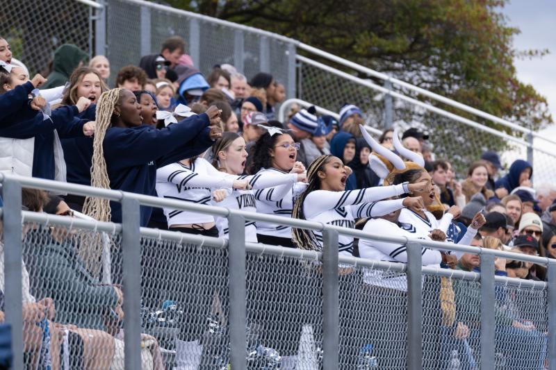 The cheer team leads cheers in the stands at Banta Bowl during the Homecoming football game.