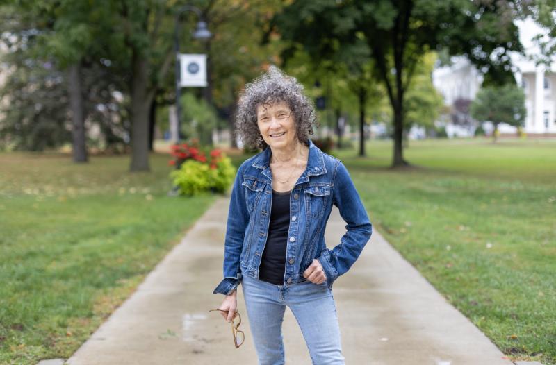 Catherine Kautsky stands on the sidewalk on Main Hall Green.