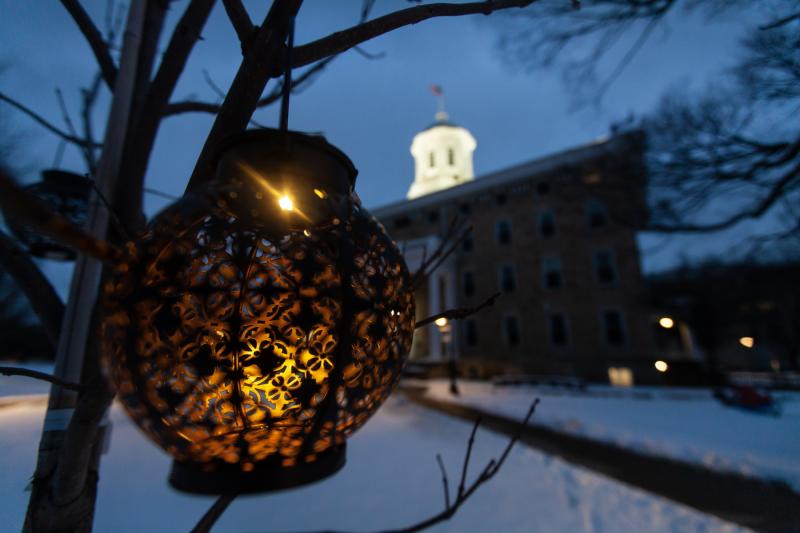 Photo of lantern in winter scene with Main Hall in the background.