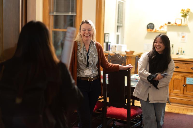 Lacy Frewerd, director of international student services, greets students at a Friendship Family gathering in International House.