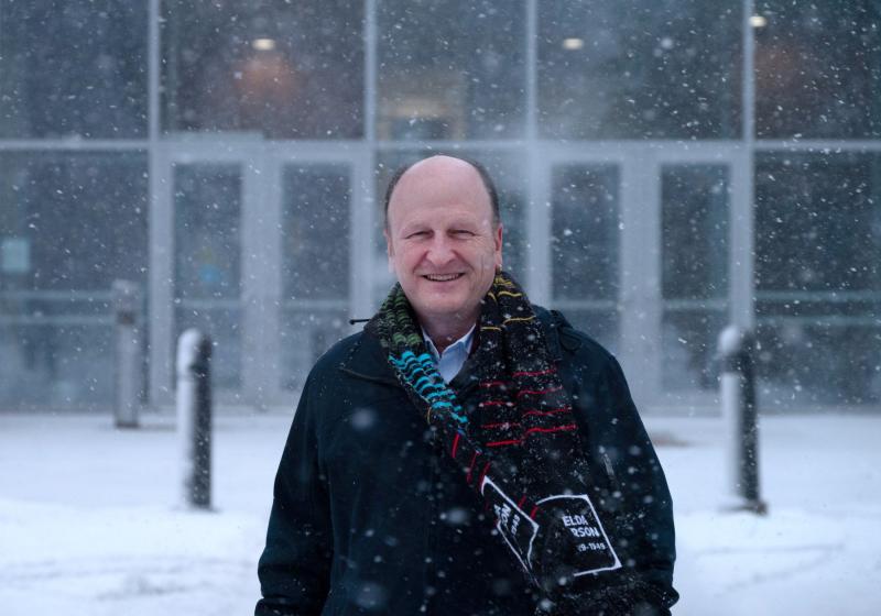 Matthew Stoneking poses for a portrait in front of Youngchild Hall as the snow comes down.