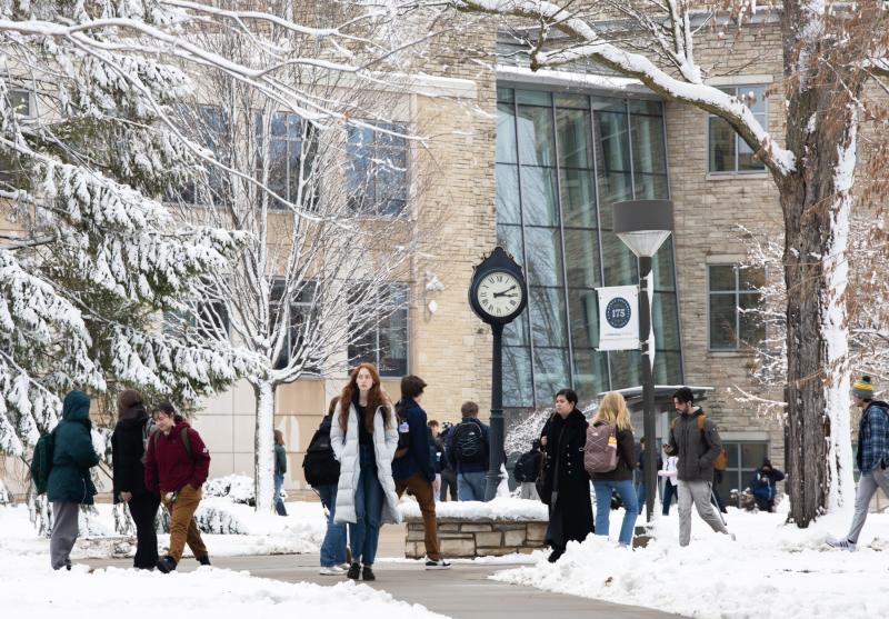 Students walk in front of Youngchild Hall following a snowfall.