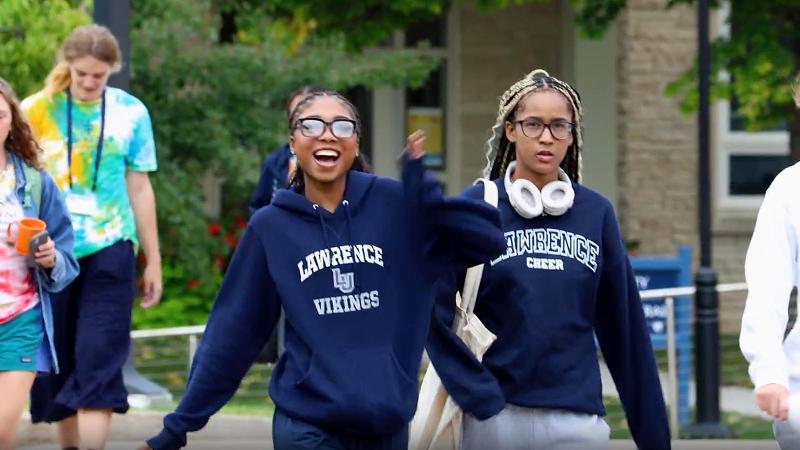Students in Lawrence apparel walking across campus