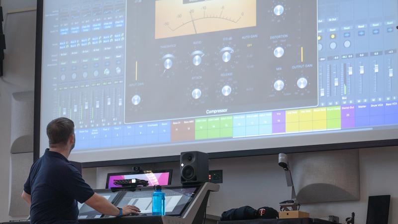 An audio engineer working on a digital audio workstation.