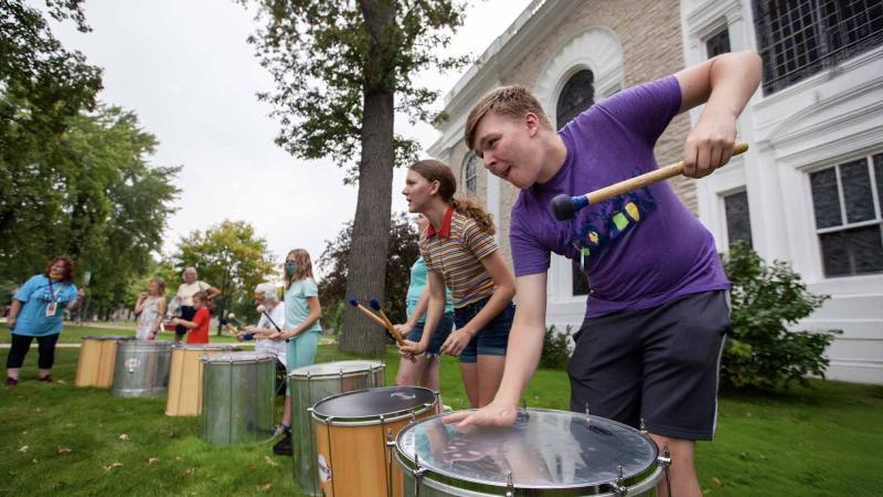 Students playing drums as part of Music Education at Mile of Music