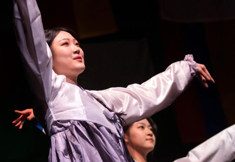 Asian students dancing in traditional attire during Cabaret