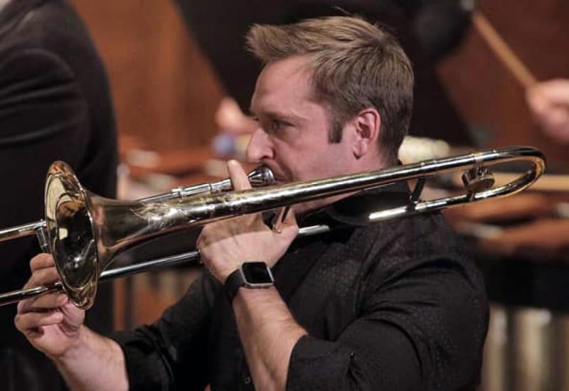 Mike Clayville playing a trombone