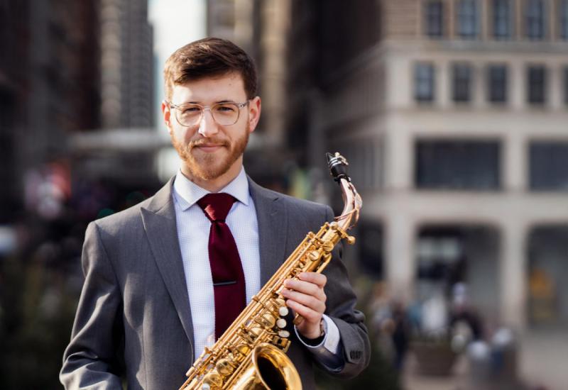Joe Conner, saxophone faculty holding a saxophone profile pic