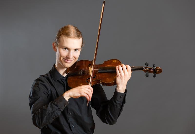 Ben Frueh poses with his violin.