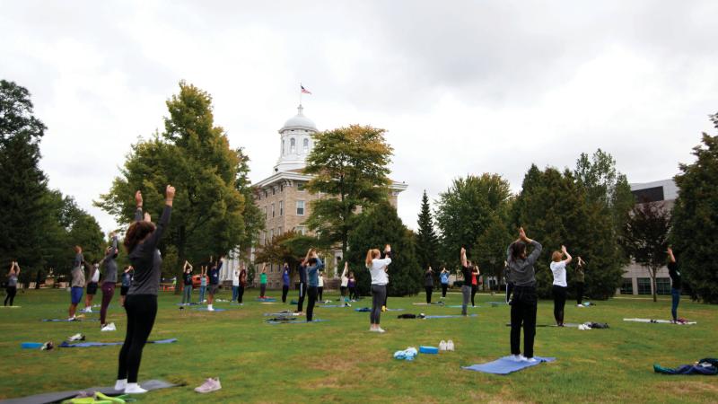 Students participating in yoga outside on Main Hall green