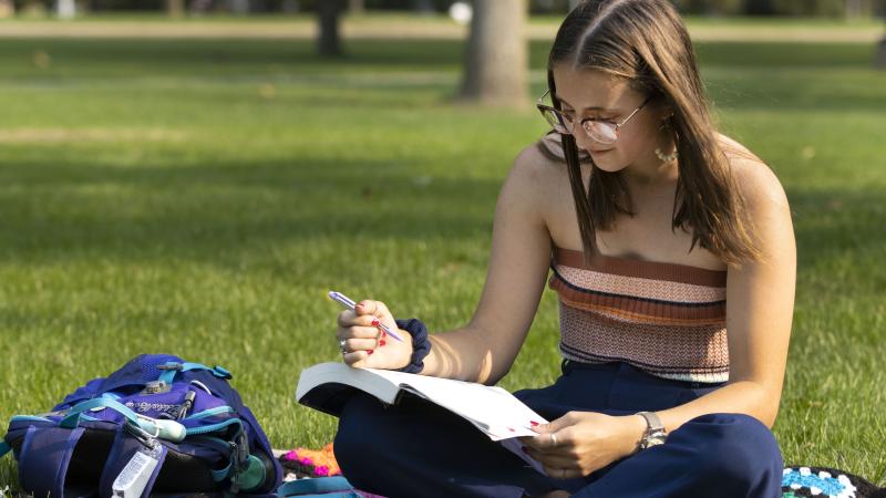 Melanie Shefchik '22 does classwork on Main Hall Green