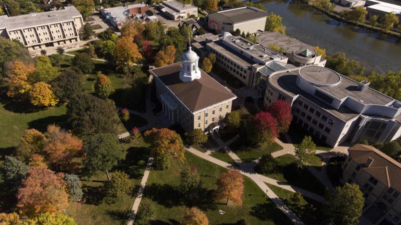 fall aerial campus view showing Main Hall, and buildings to south and east of that with brilliant fall colors